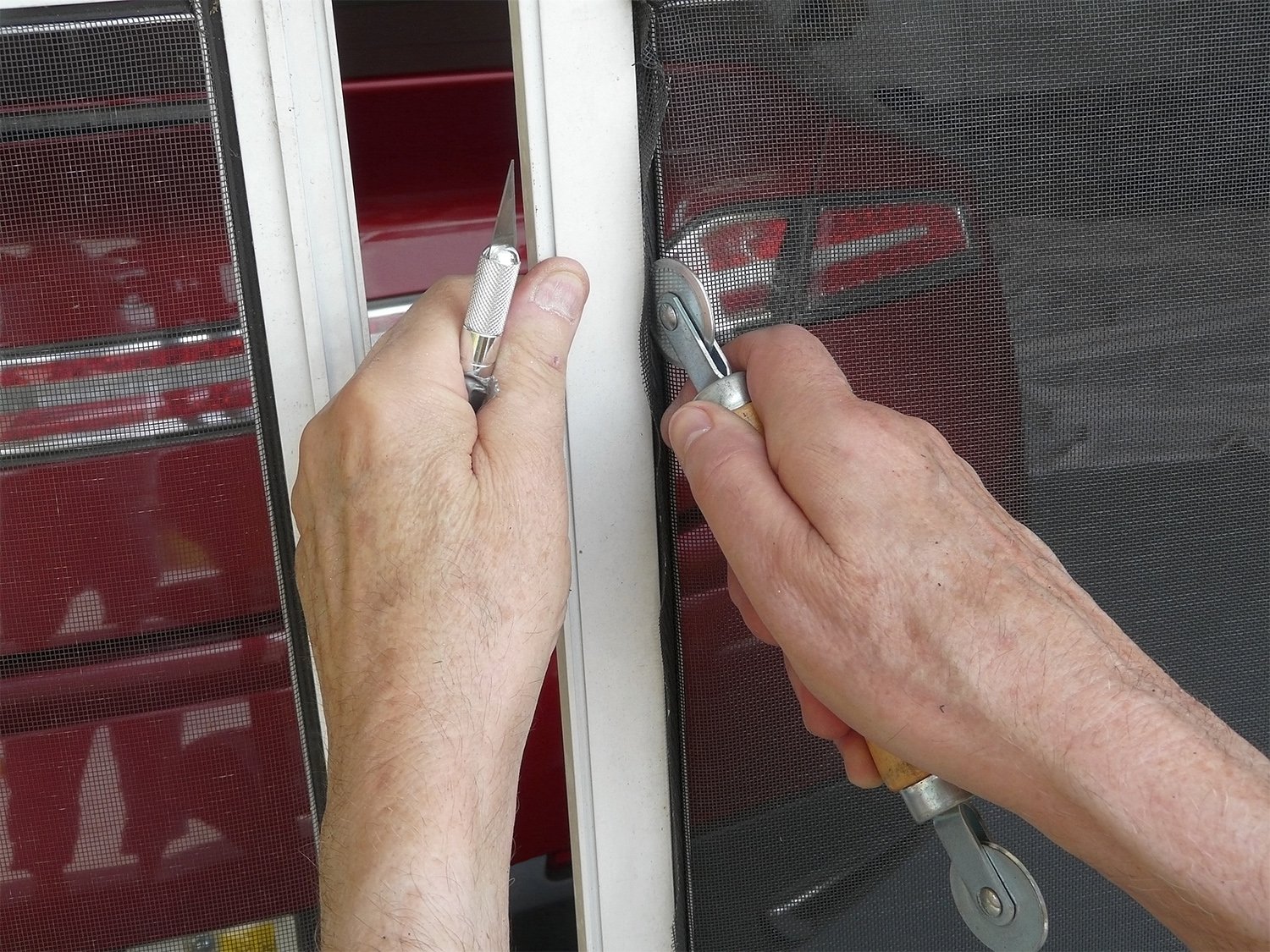 Person installing garage screen door