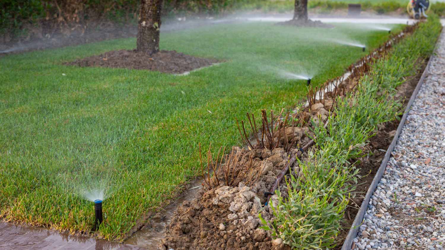 A lawn sprinkler system watering the grass