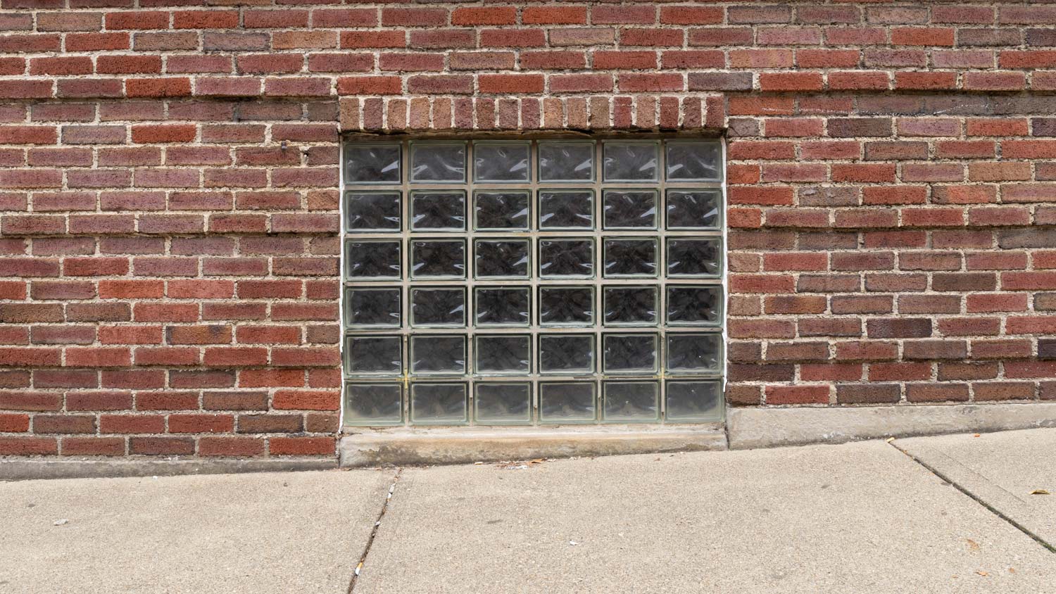 Straight on view of a glass block basement window