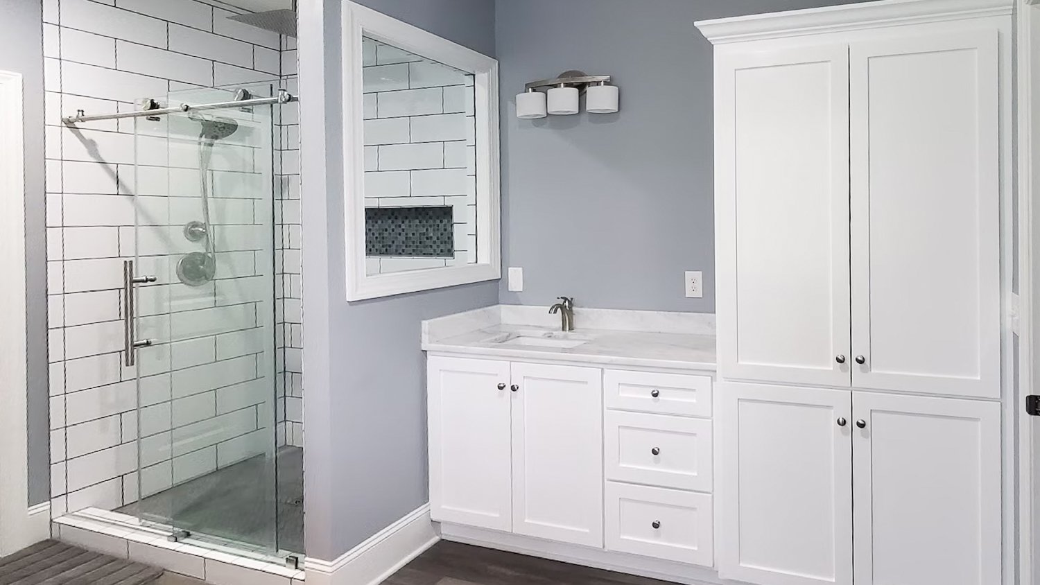 Gray bathroom with glass shower 