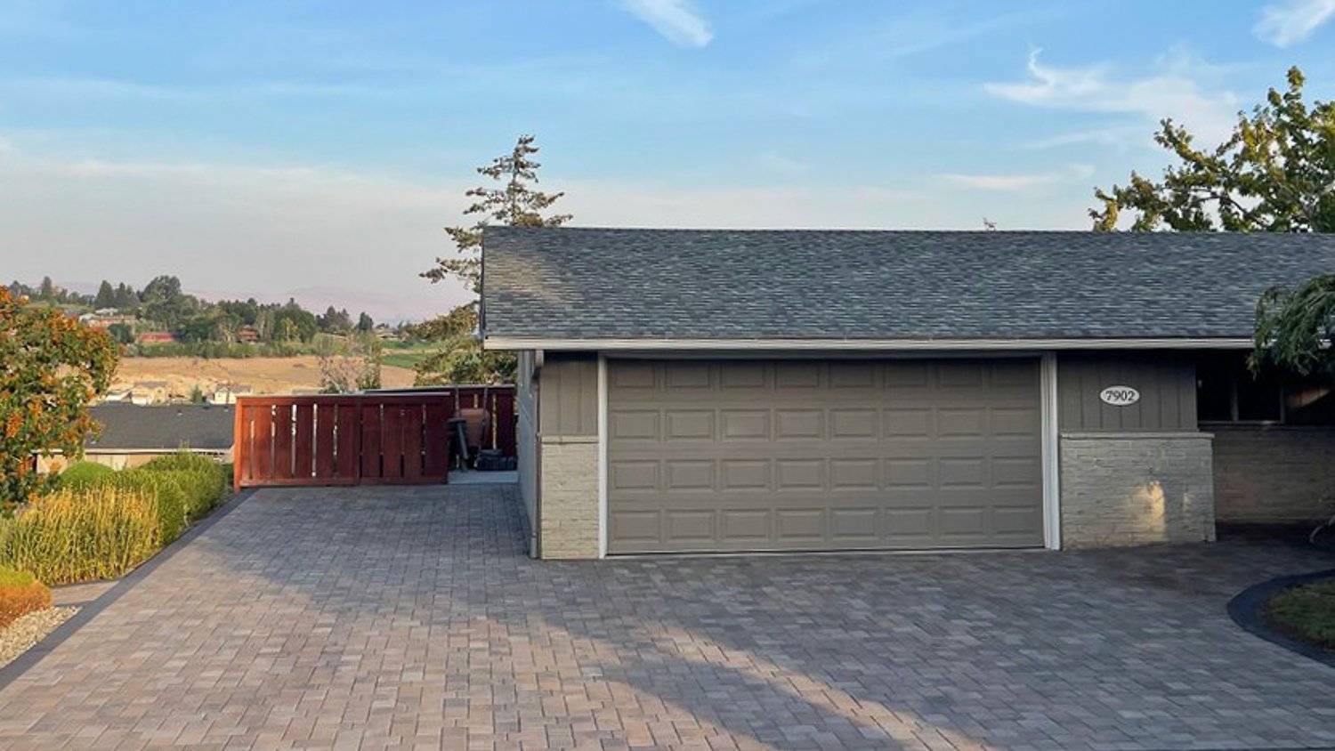 Gray house with L-shaped driveway