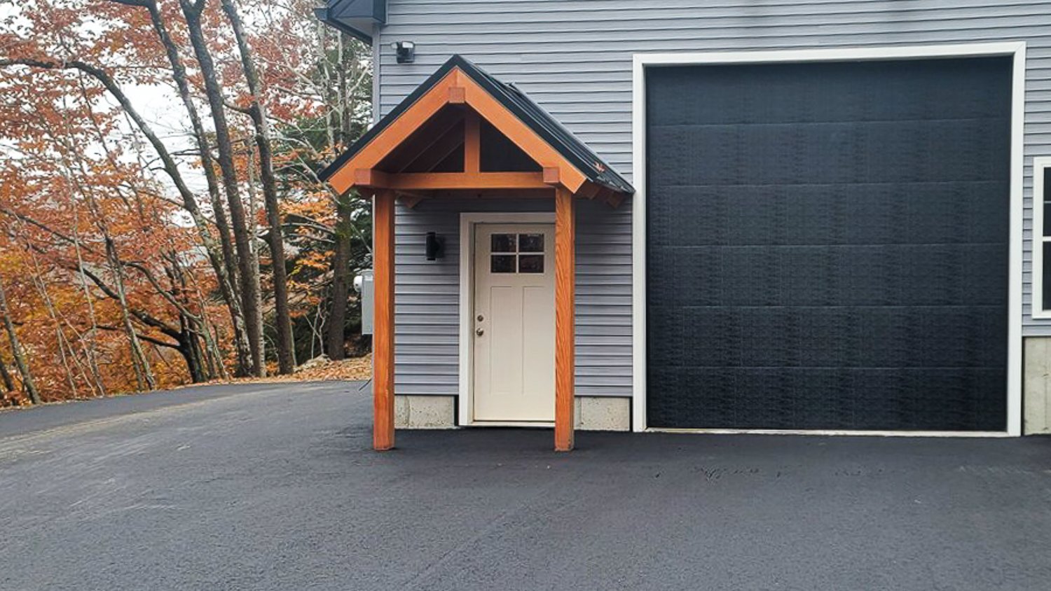 Gray house with asphalt driveway