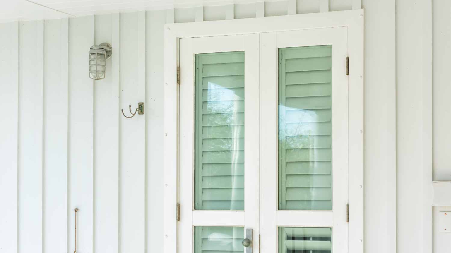 Green hurricane window shutters