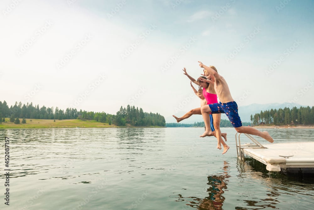 Group of kids jumping off the dock