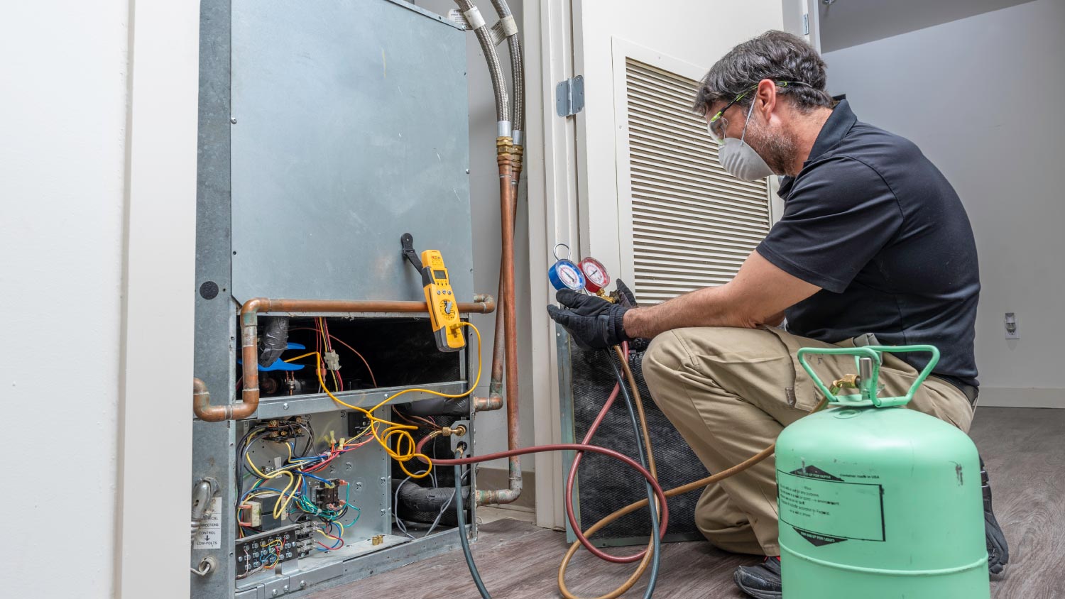 HVAC worker checking refrigerant