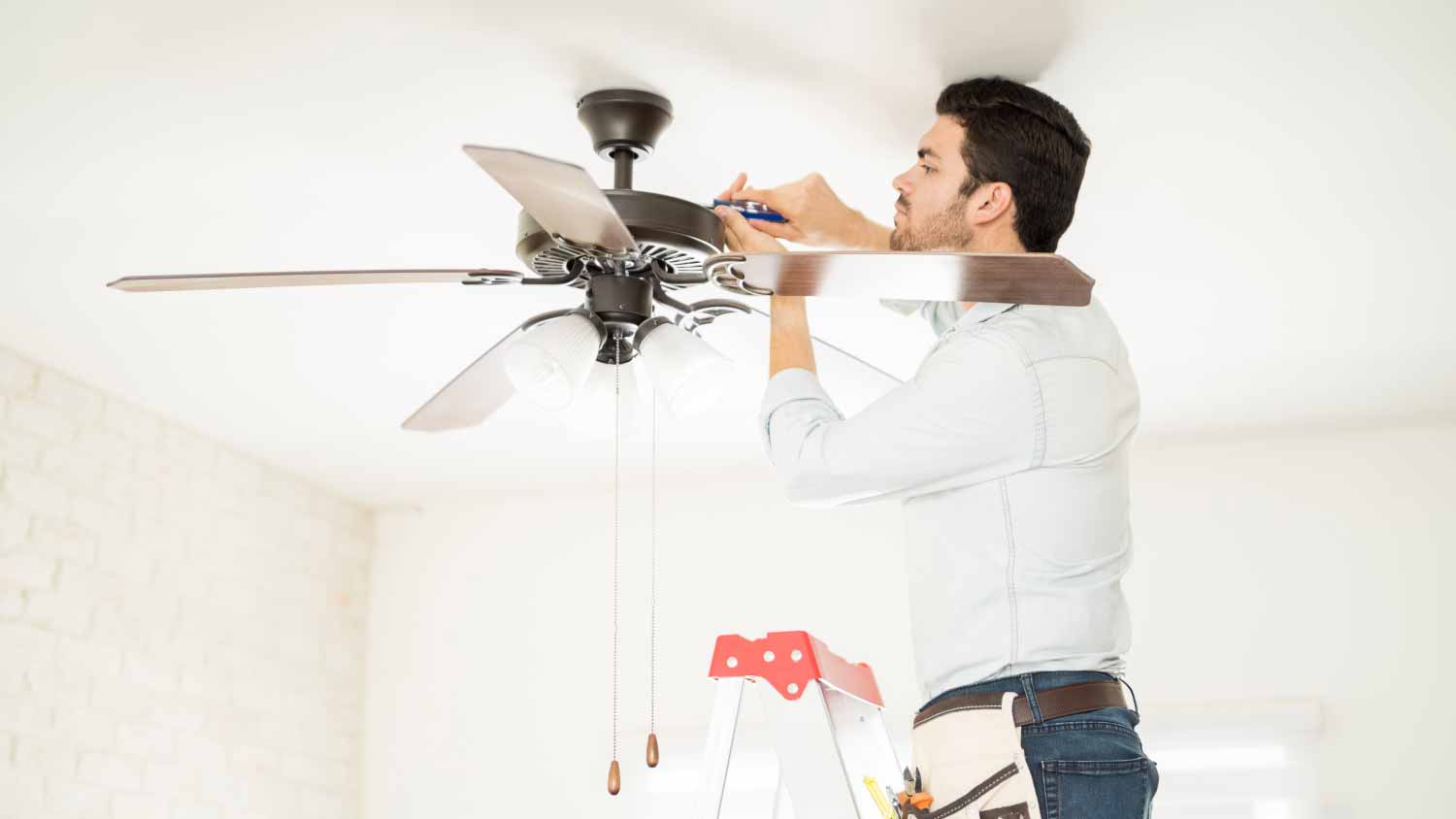 Handyman installing a ceiling fan