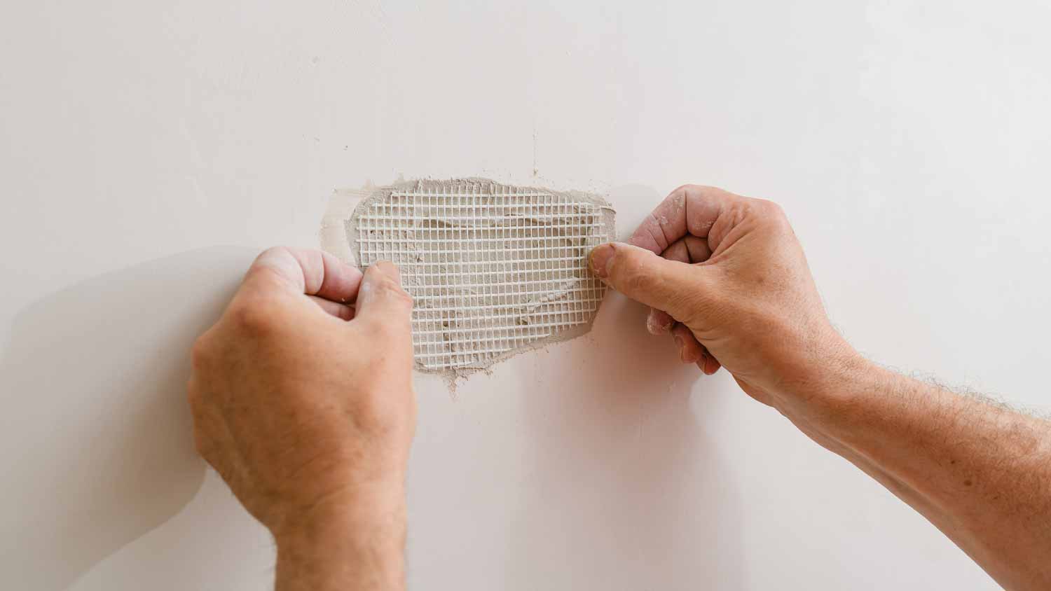 Handyman repairing a hole in the drywall