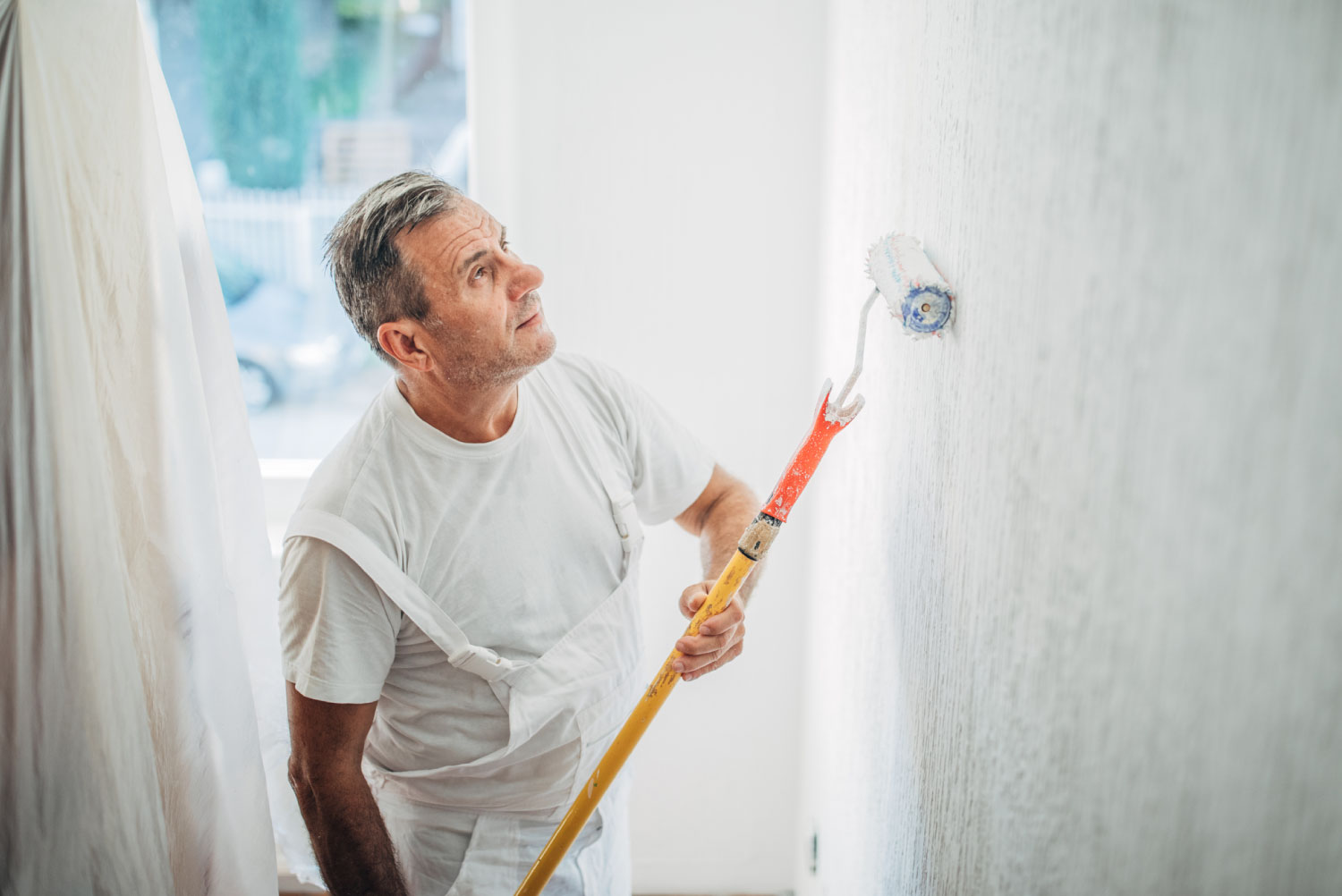 A handyperson painting a wall