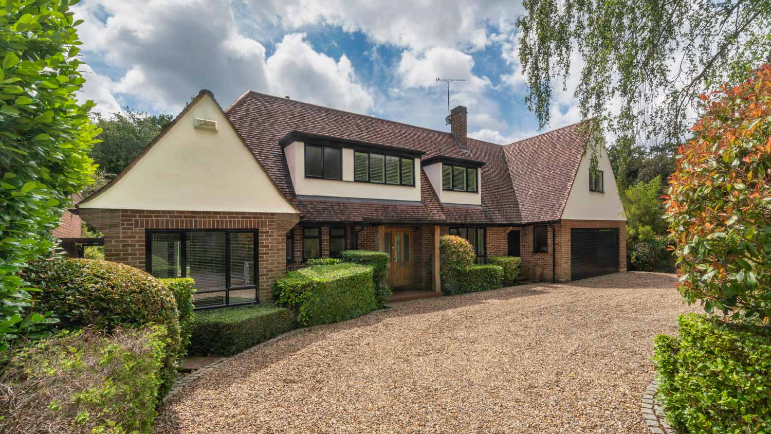 House with gravel drive and landscaped garden