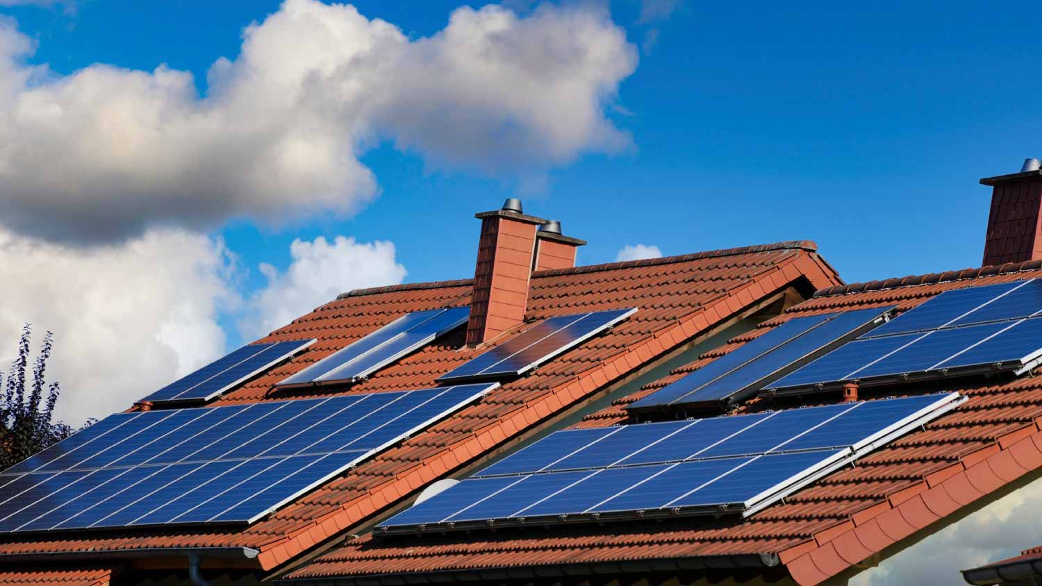 House with solar panels on a tiled roof