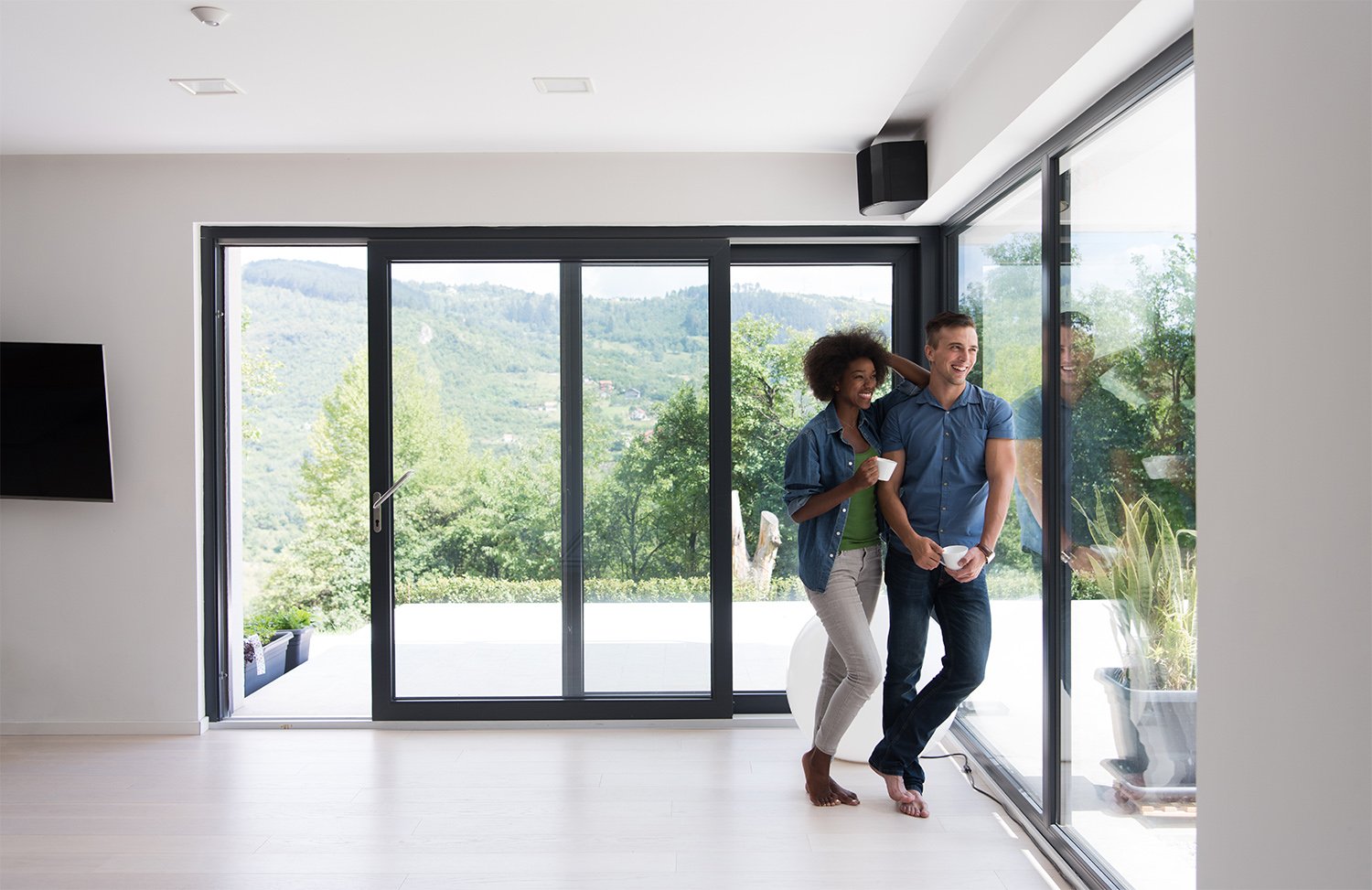 Husband and wife looking out window