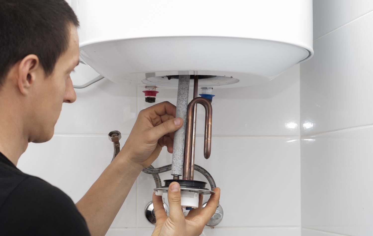 A man inspecting an anode rod