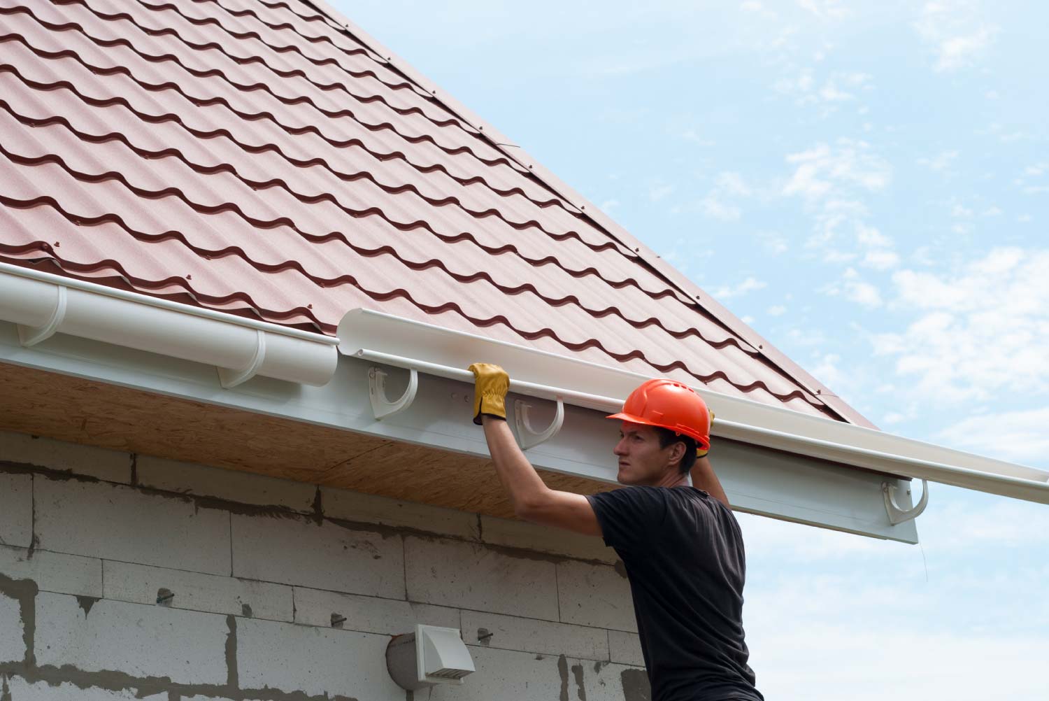 Worker installing the gutter system