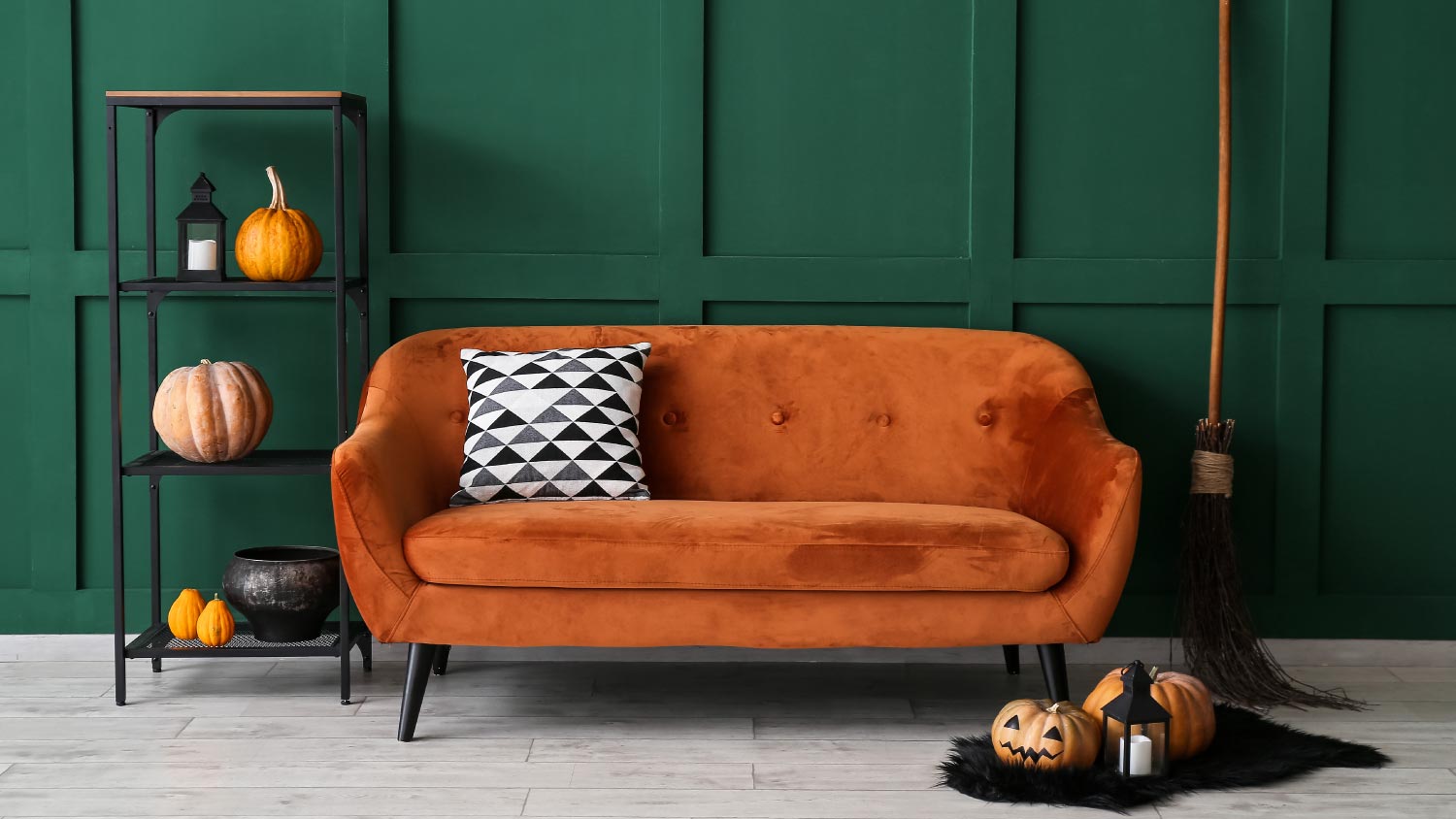 Interior of stylish room with sofa and Halloween decorations