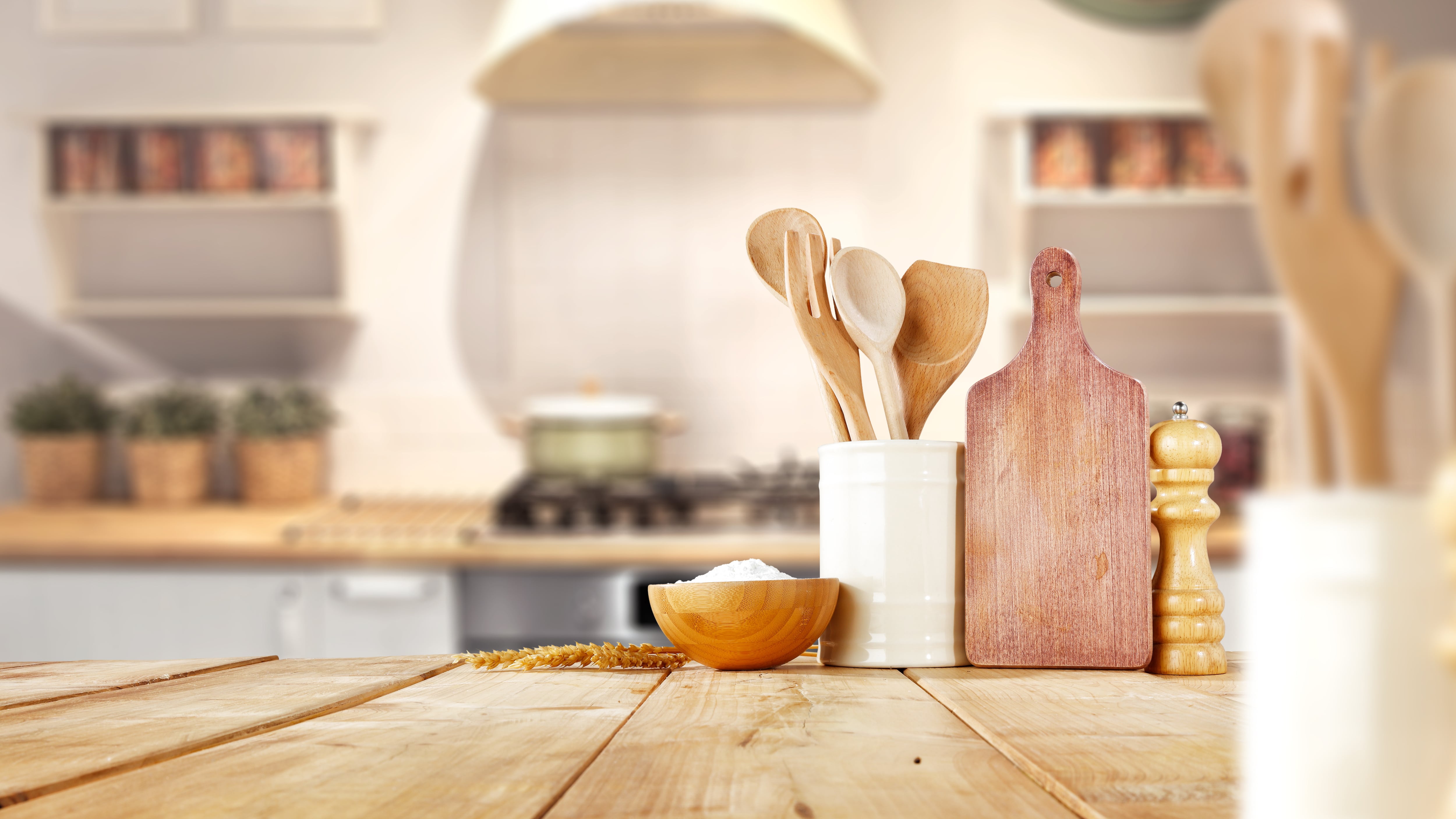 Reclaimed wood kitchen countertop with cheese board and cooking utensils
