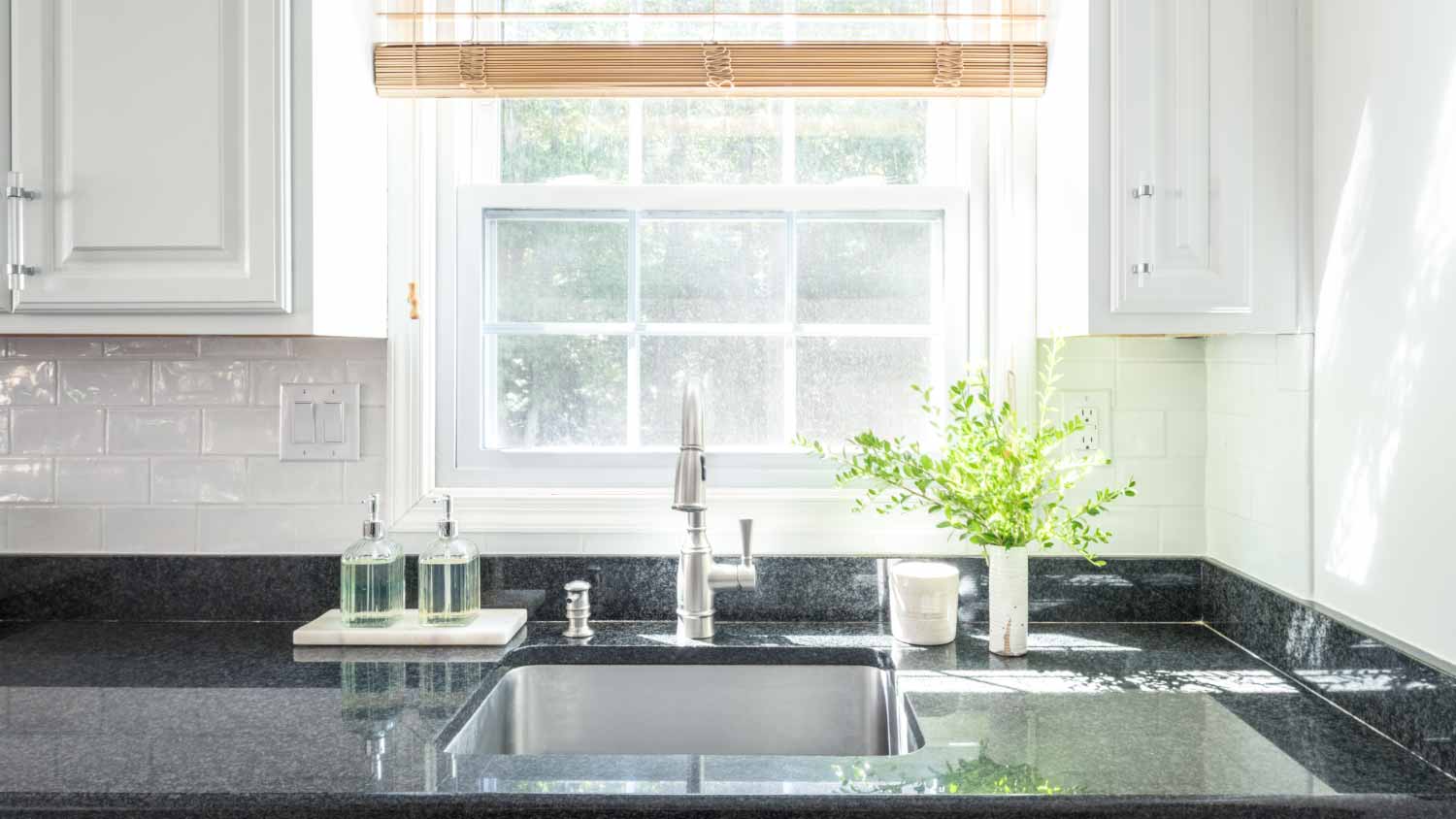 Kitchen sink by window at home