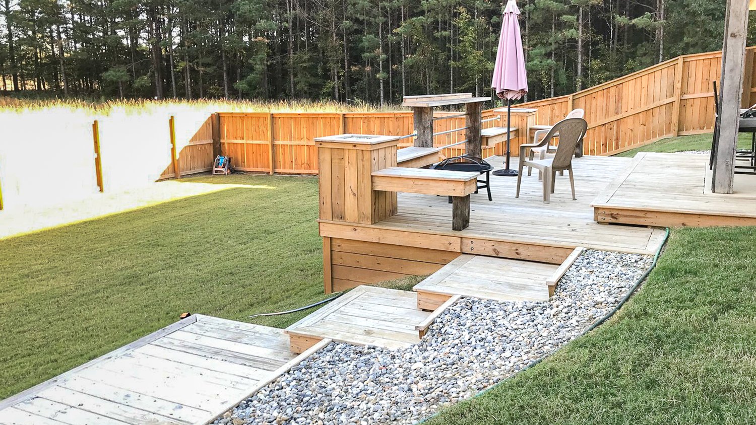 Large backyard with wooden deck 