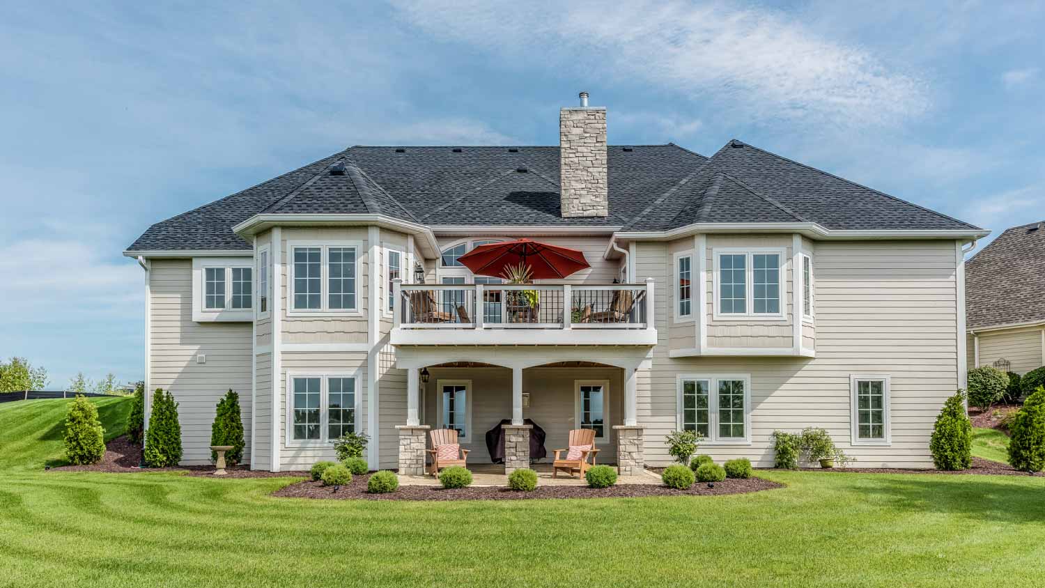 Large home with deck above