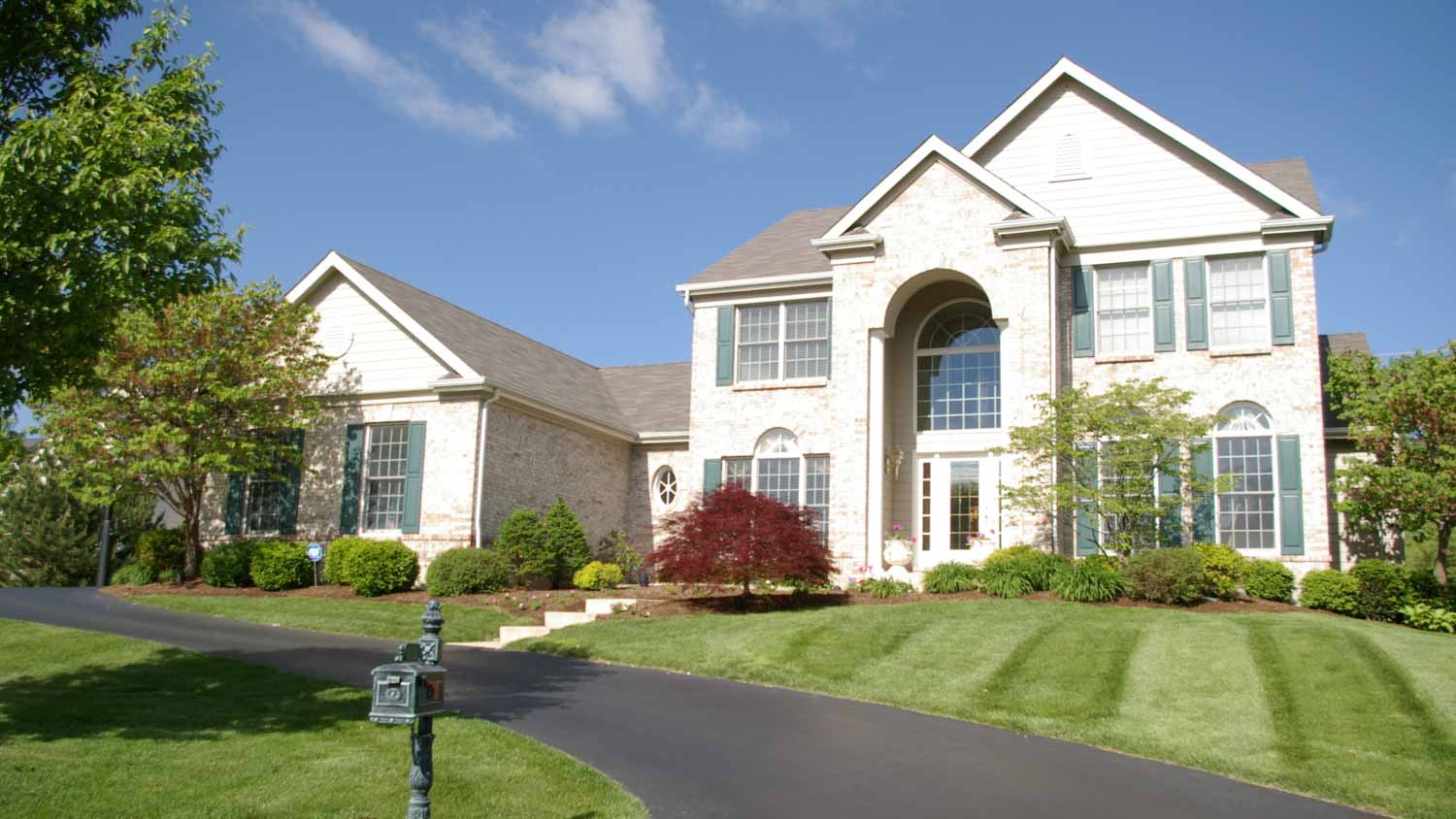 Large white house with a driveway