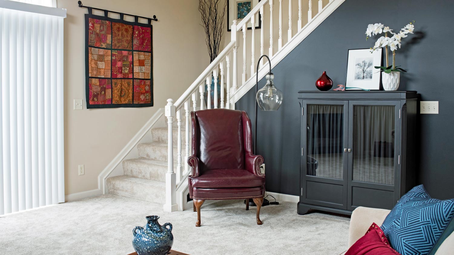 Living room staircase with black accent wall