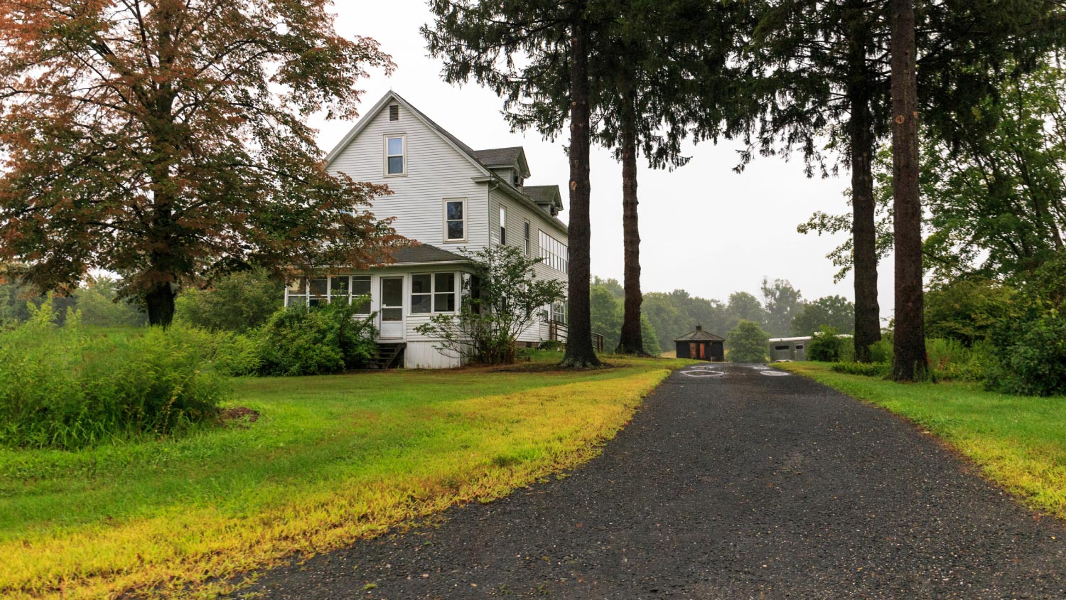 A long driveway to large rural American home