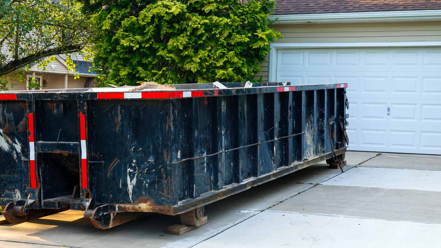 Long dumpster full of wood