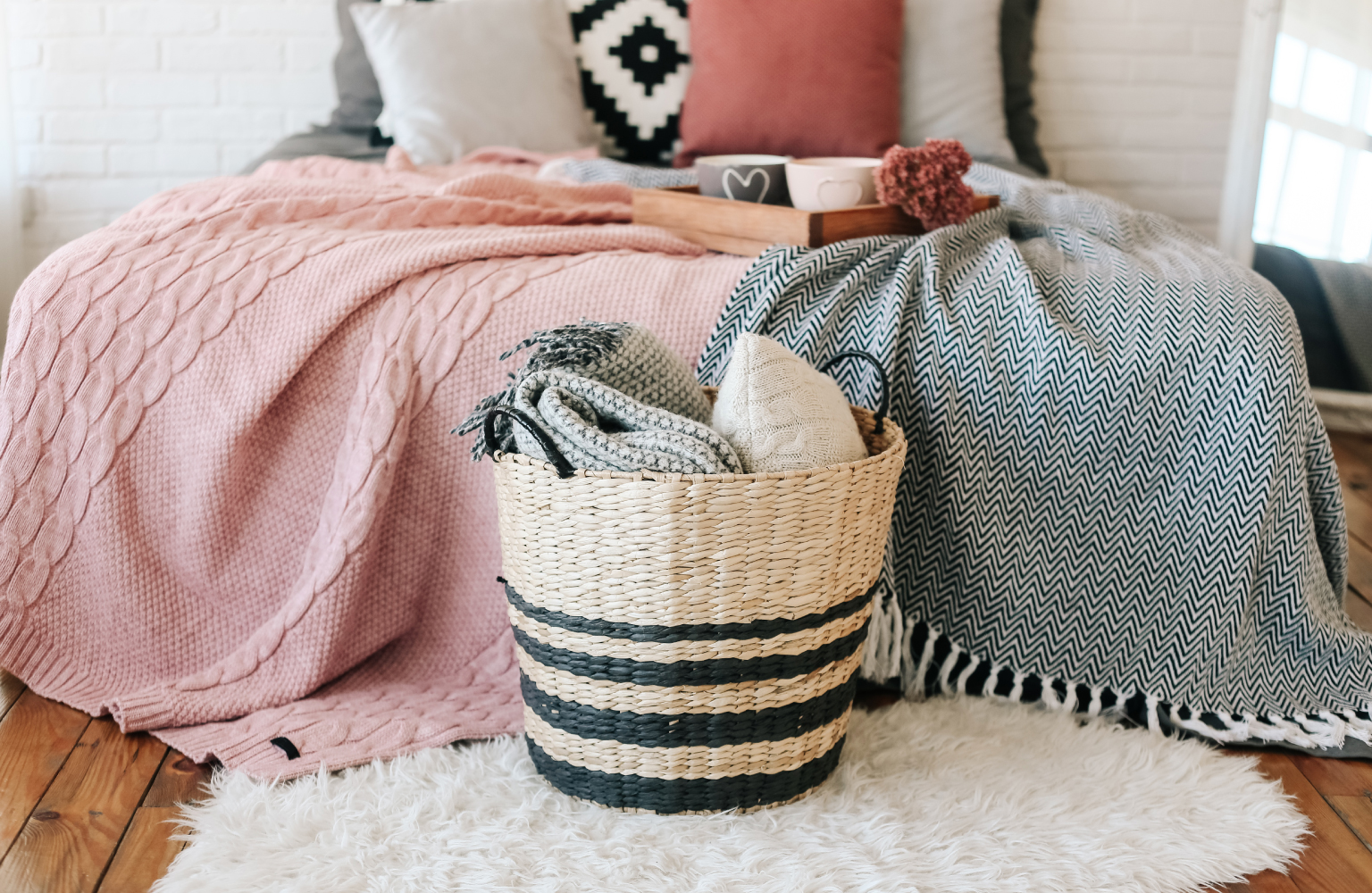 basket with blankets in bedroom 