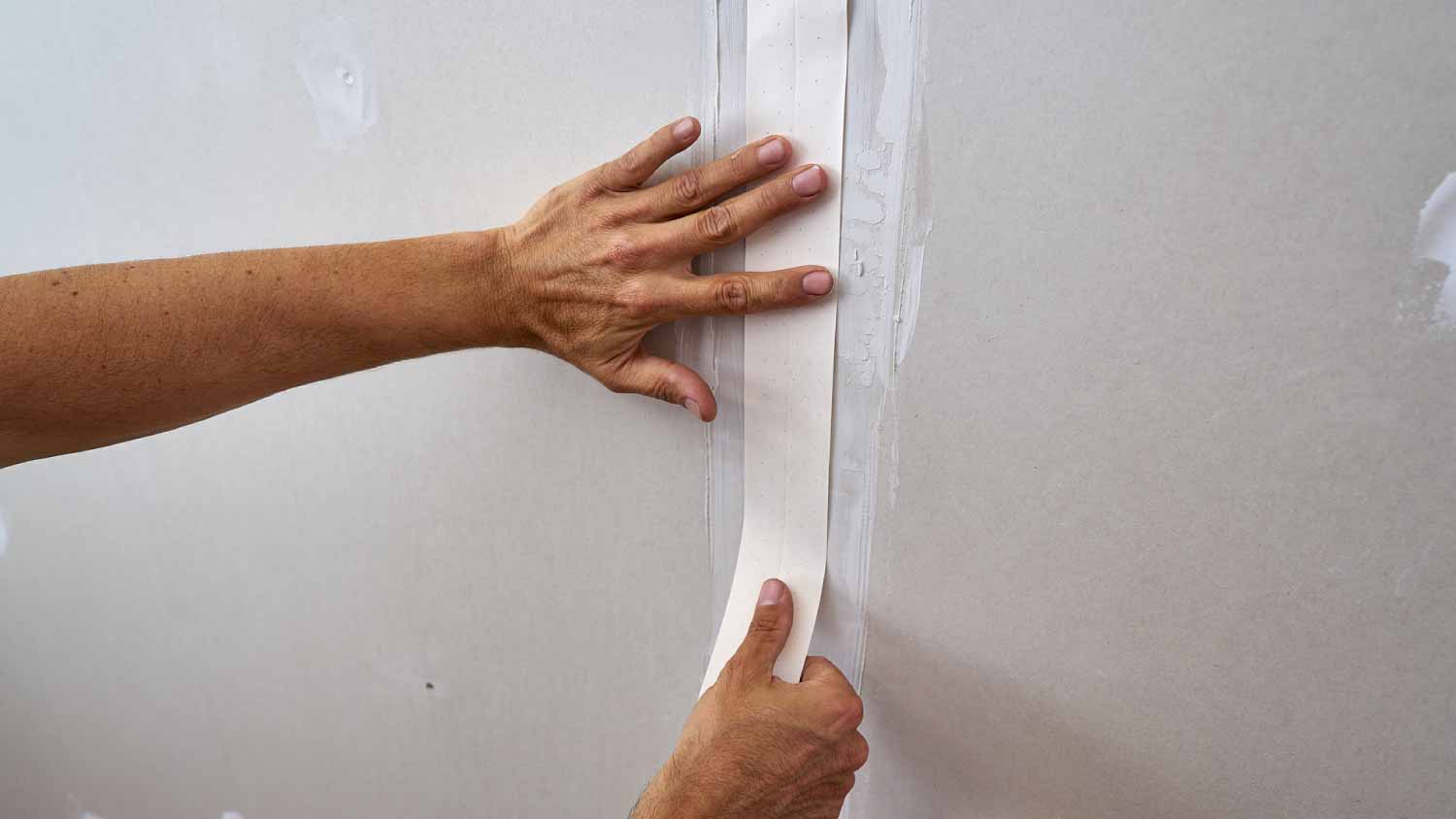 Man adding laminated plasterboard