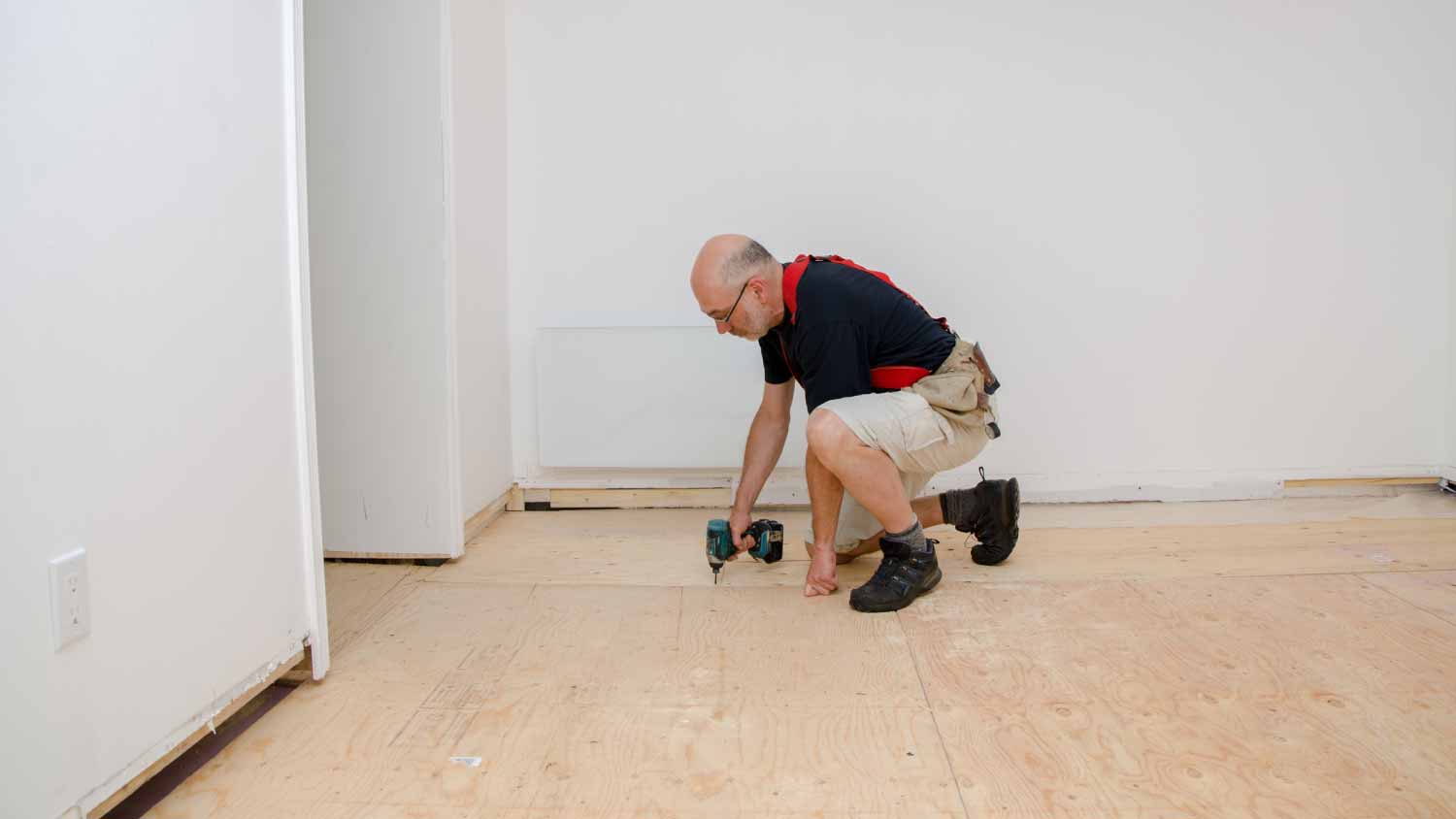 Man building a floor in basement