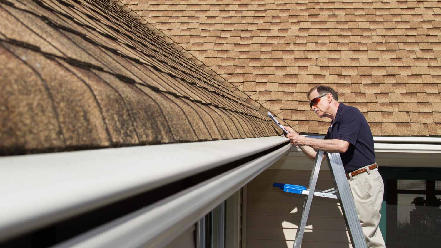 Man checking curve gutter guards