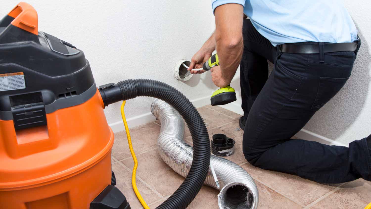 Man cleaning dryer vent