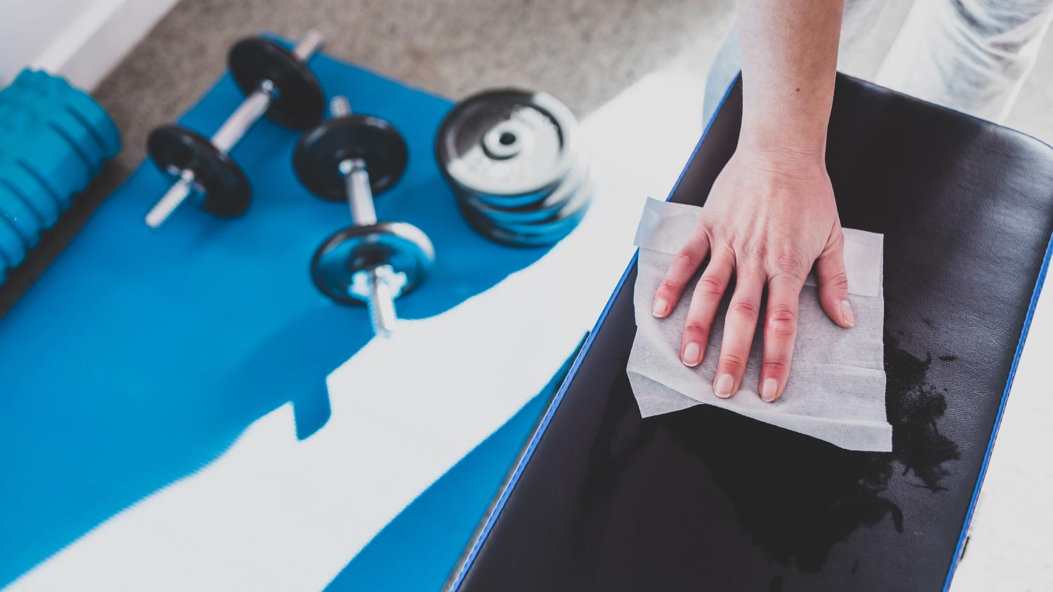 Man cleaning gym equipment