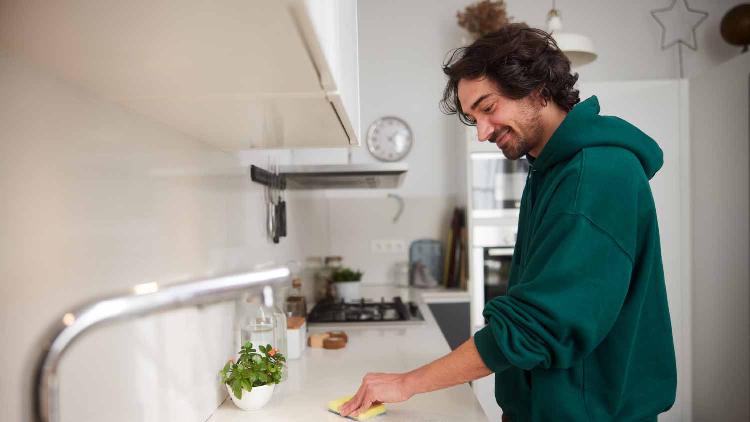 Man cleaning kitchen counter