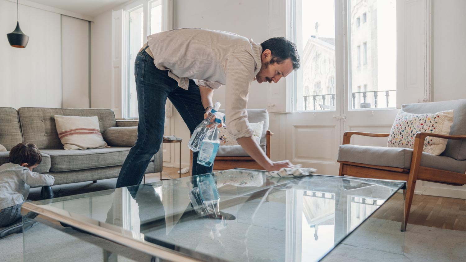 Man cleaning table on living room