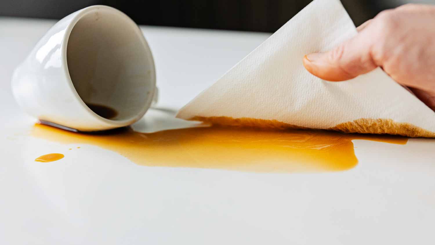 Man cleaning up spilled coffee