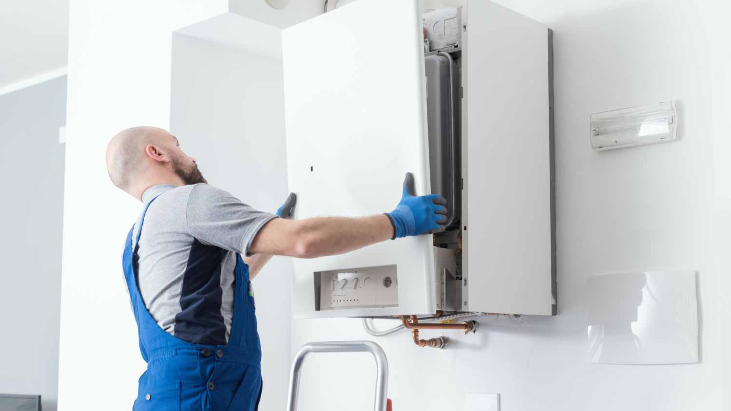 Man doing a boiler inspection at home