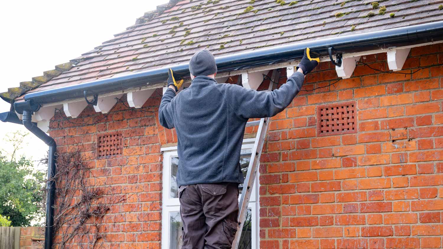 Man fixing rain gutter