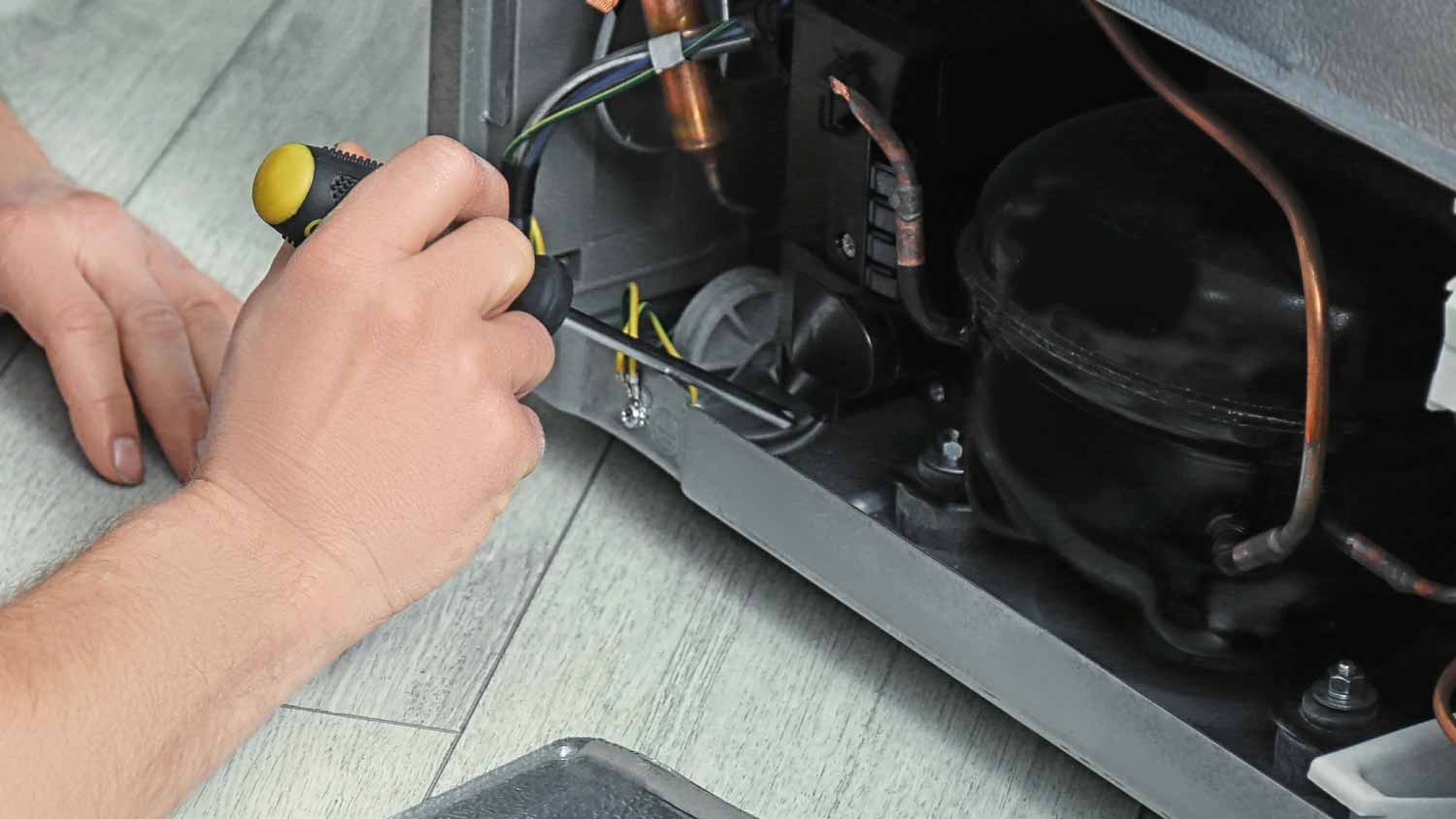 Man fixing refrigerator