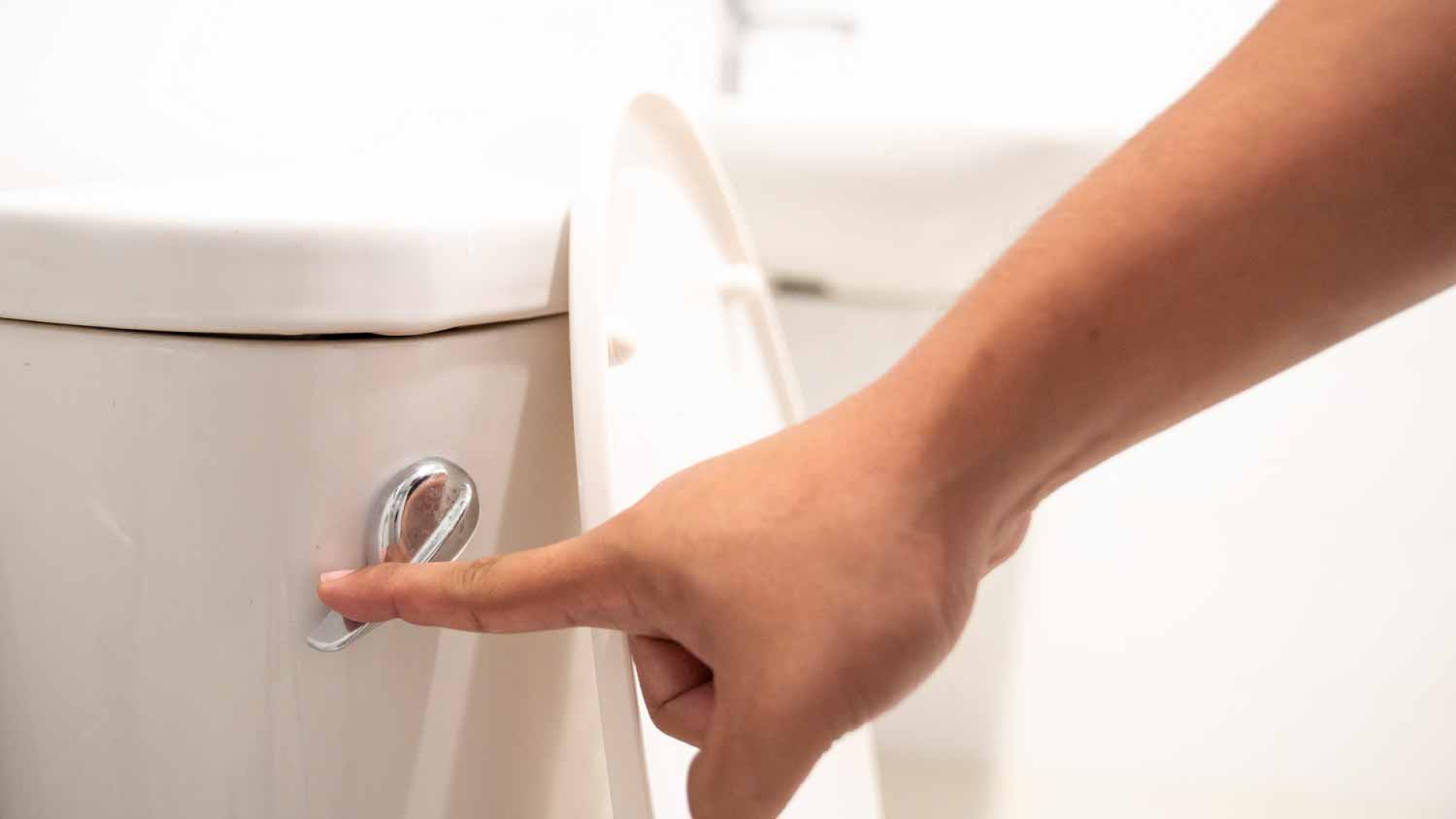 Man flushing toilet