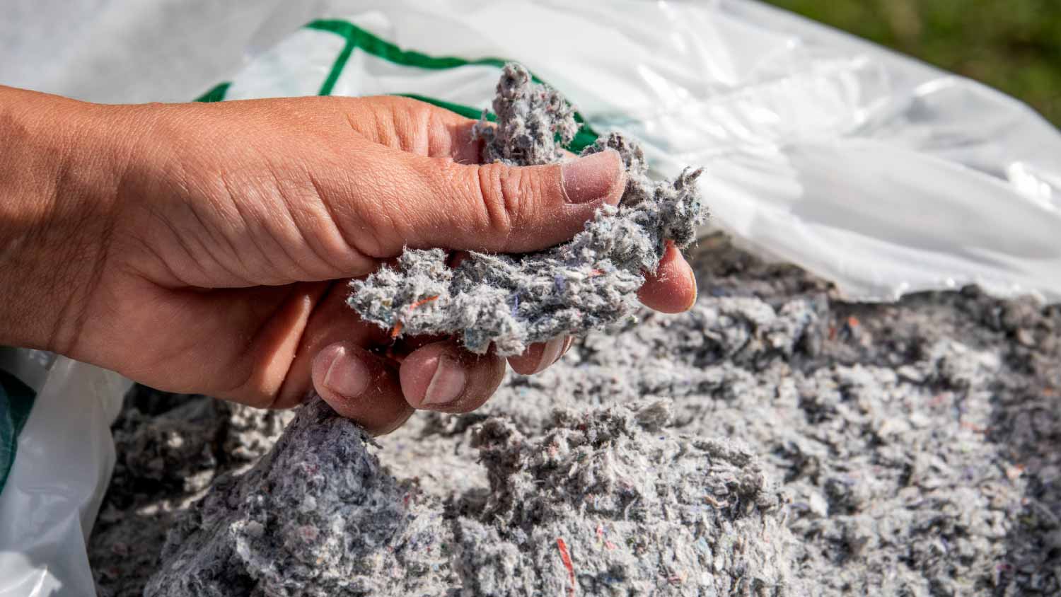 Man holding cellulose insulation