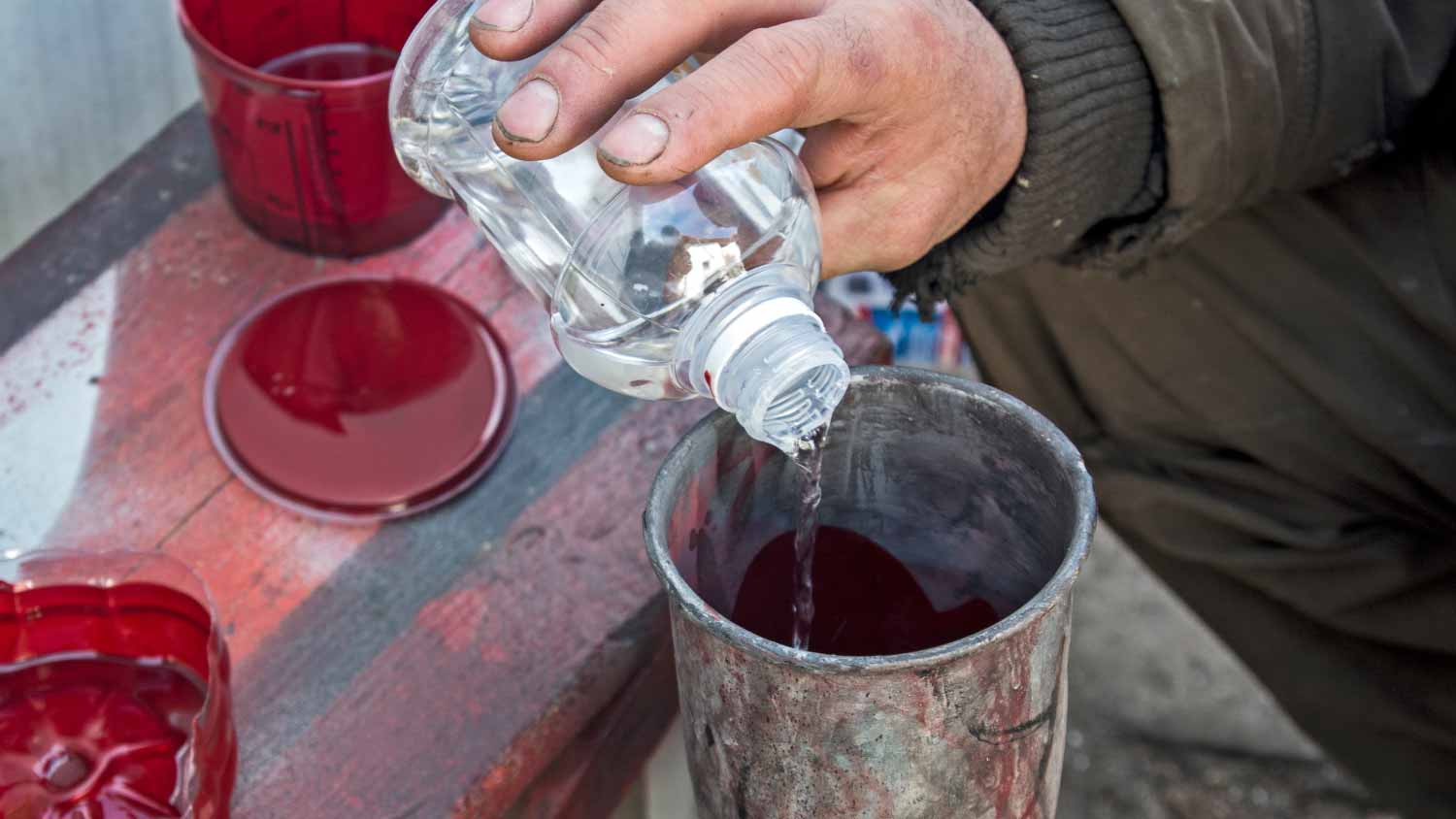 Man holding thinner bottle