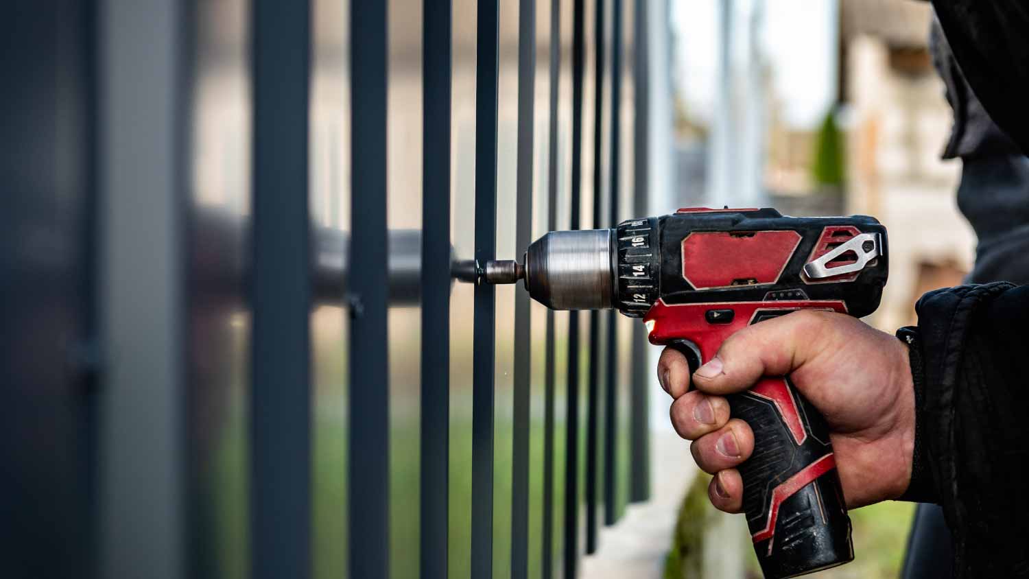 Man installing metal fence