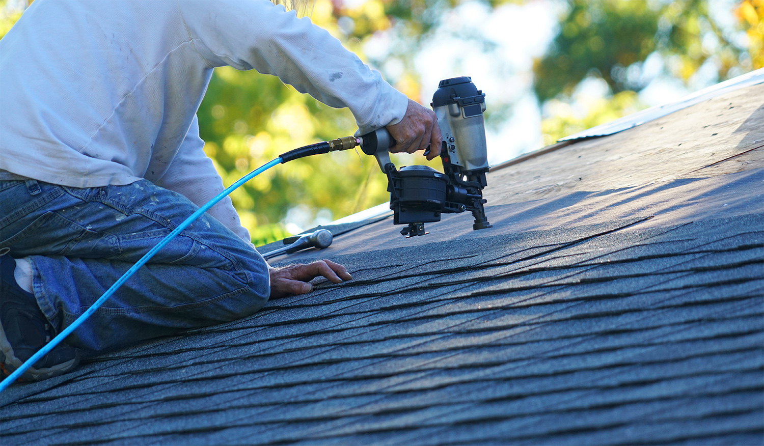 Man installing shingles on the roof