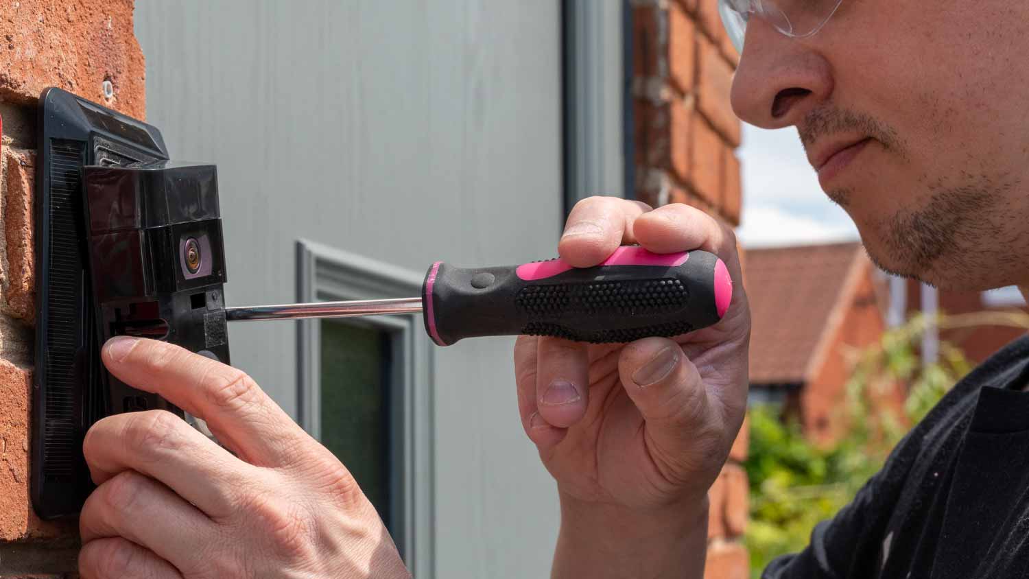 Man installing a smart doorbell