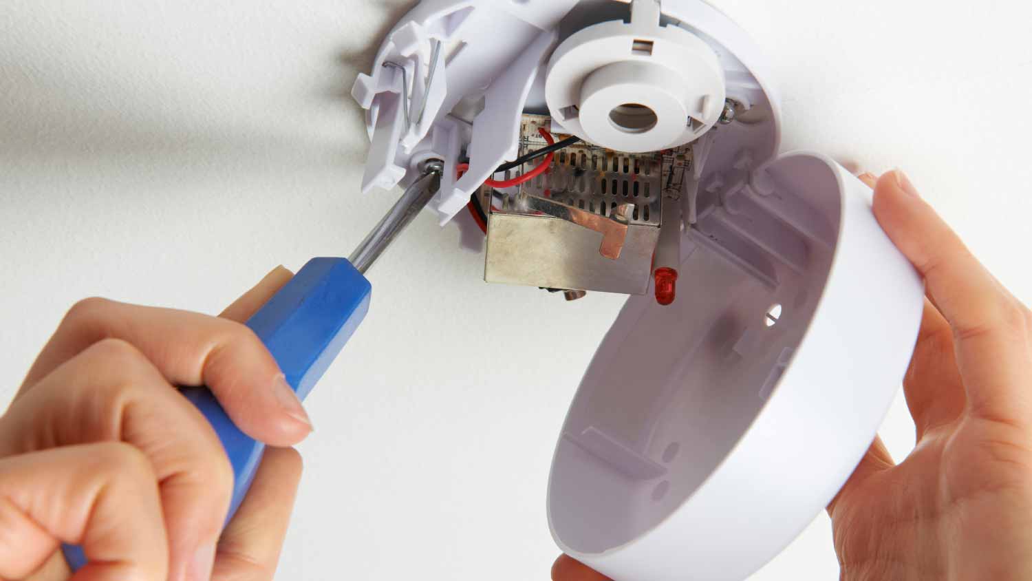 Man installing smoke detector