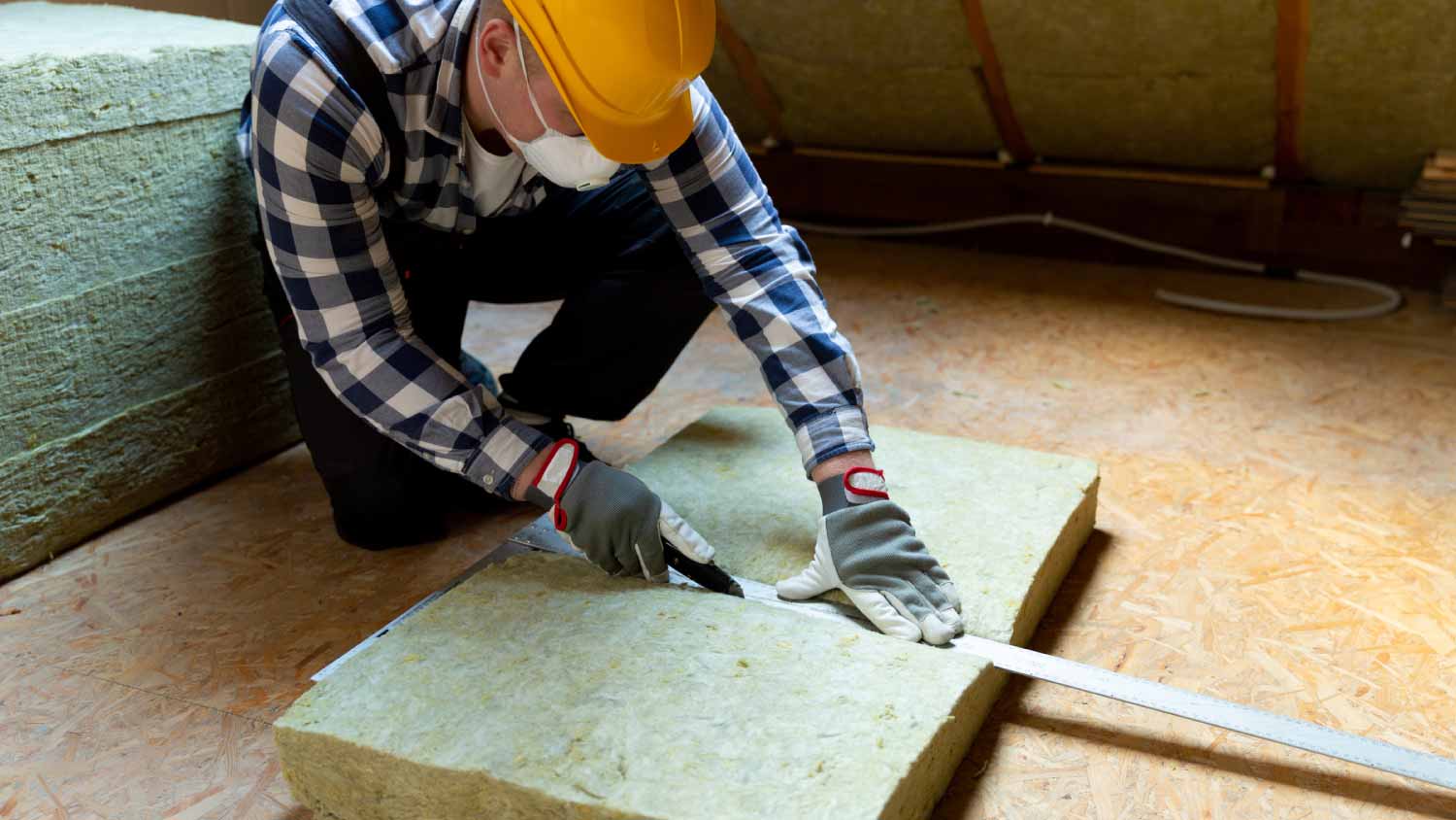 Man installing thermal roof insulation layer