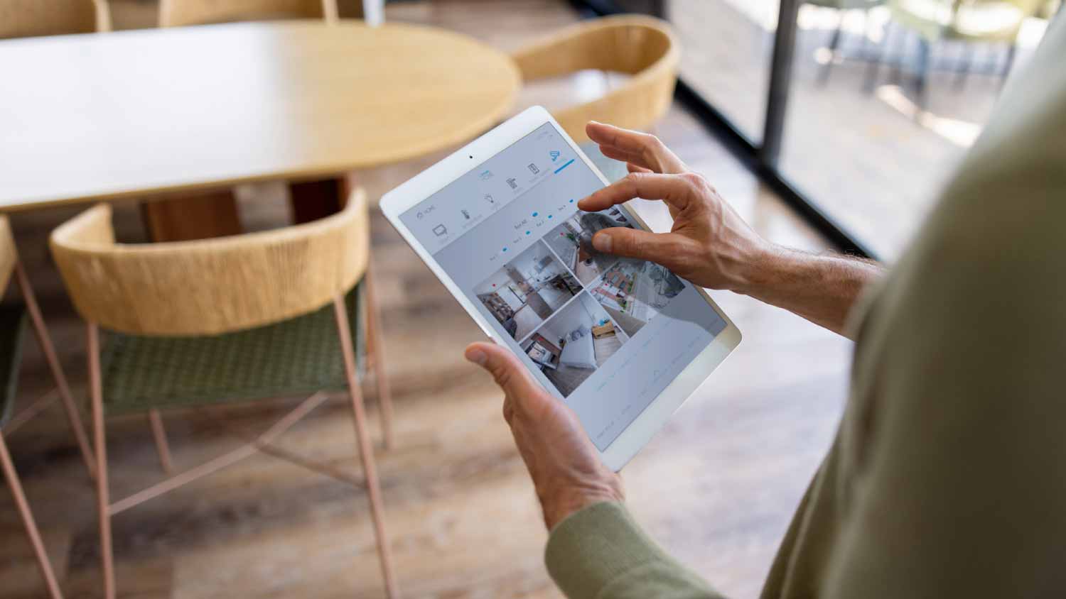 Man monitoring his smart home using a security system