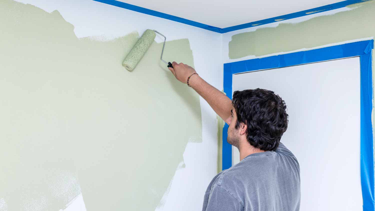 Man painting bedroom walls