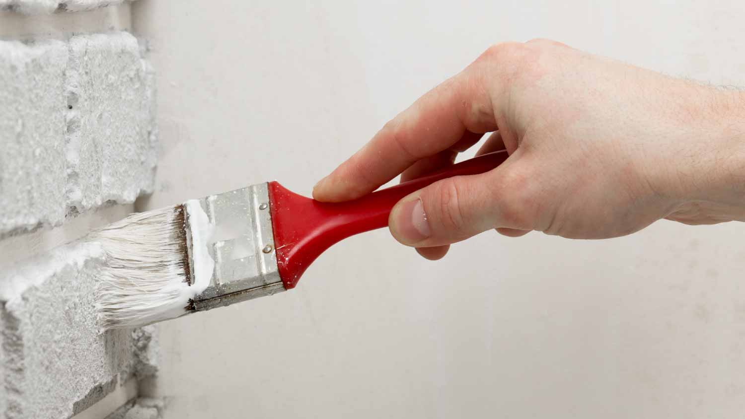 Man painting bricks 