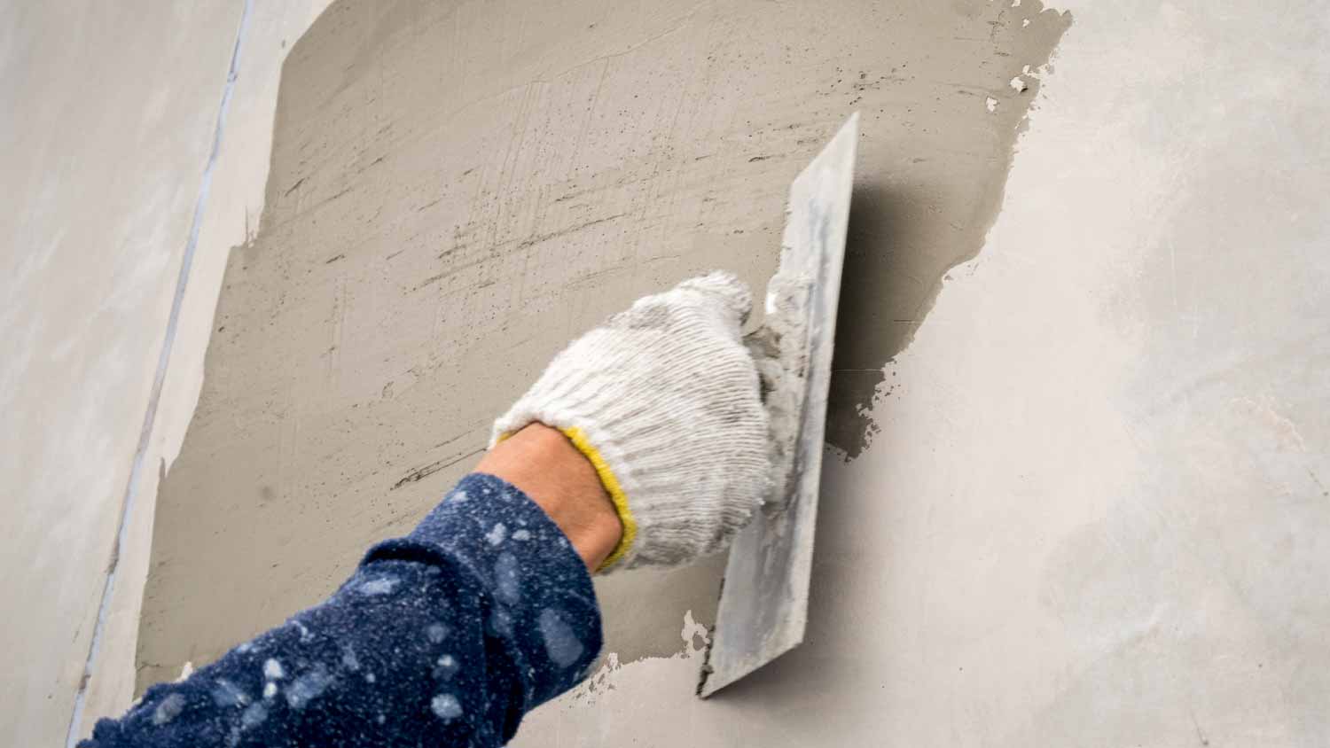 Man plastering wet cement